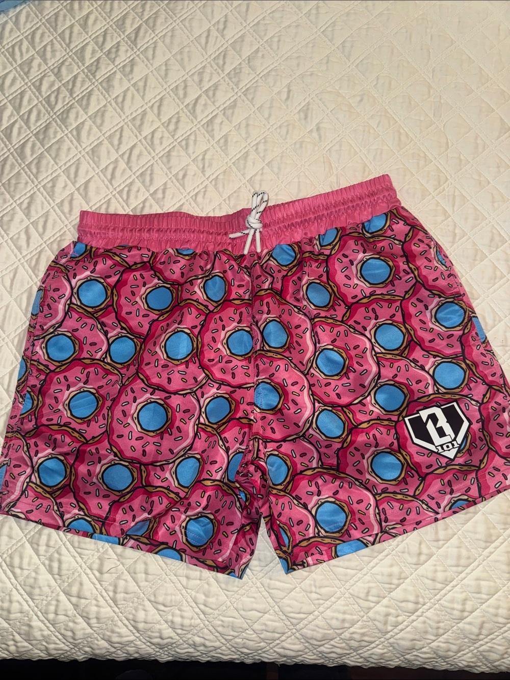 Men's Pink Donut Print Swim Trunks with Blue Accents